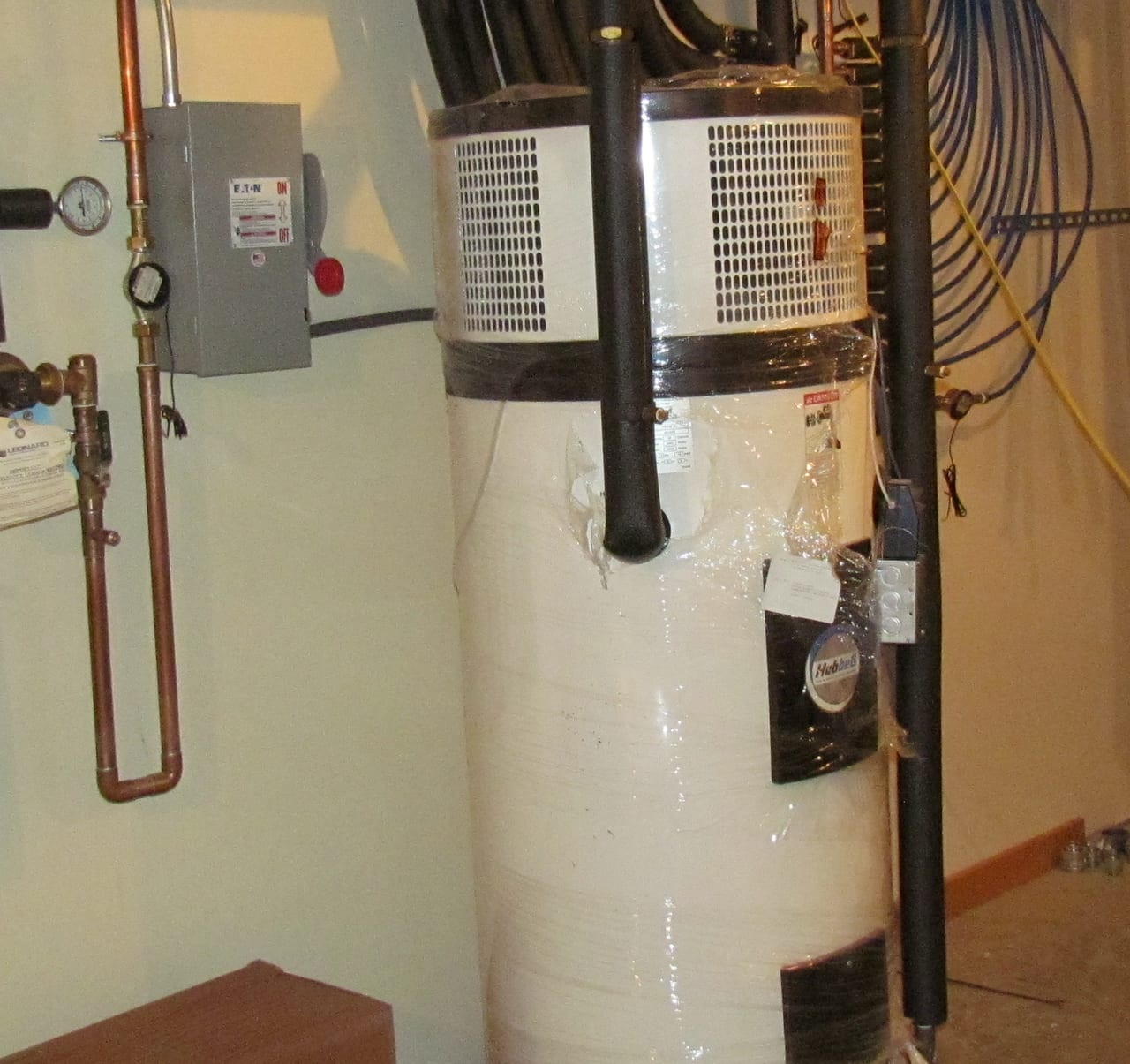 Heat-pump tank water heater and insulated connections in a residential research installation